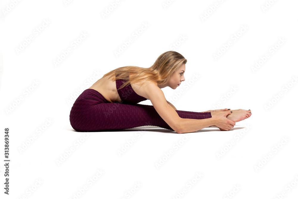blonde girl doing gymnastic stretching dressed in sportswear with white background blonde girl doing gymnastic stretching dressed in sportswear with white background