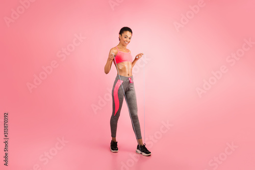 Afro Woman With Jump Rope Smiling At Camera, Pink Background