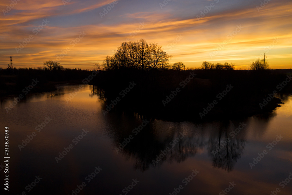 Aerial: dramatic sunrise above the river