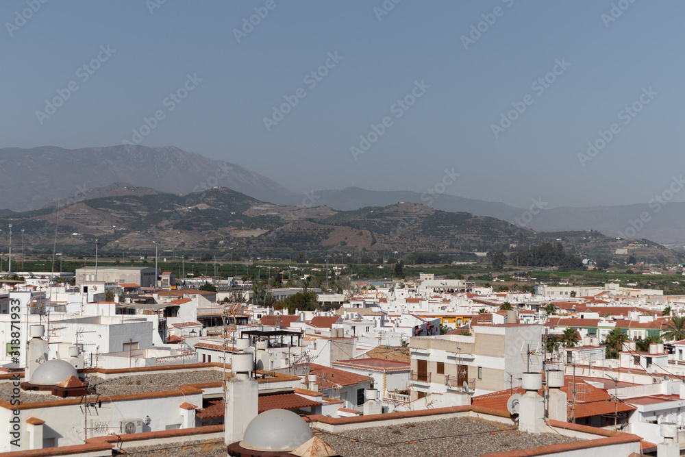 View of white houses from above and with the mountains in the background (Salobreña, Granada, Spain)