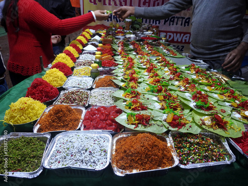 Fotografie Banarasi paan or betel leaf garnished with betel nut and all indian colorful ban