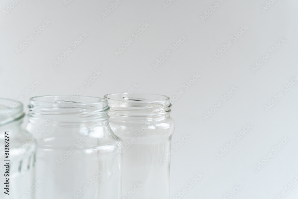 Glass jars at gray monochrome background. Zero waste concept.