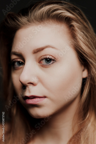 portrait of blonde girl with blue eyes and big bokeh