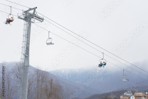 Skiers and snowboarders on a ski lift. Ski resort