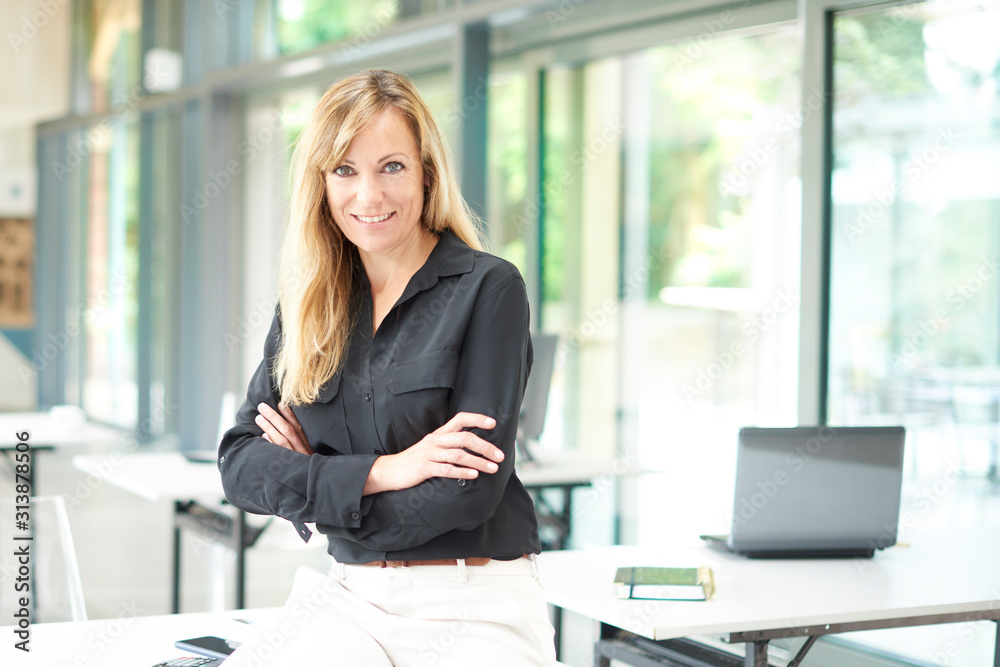 Attractive businesswoman standing in the office Attractive businesswoman standing in the office