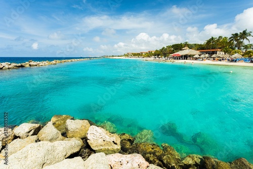 Amazing view of turquoise water of Atlantic ocean and blue sky with white clouds. Curacao island.. Beautiful nature background.