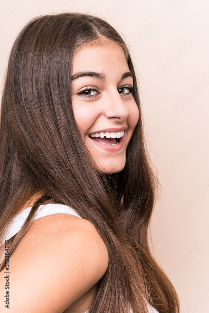Fototapeta premium Young cute caucasian woman against a beige background