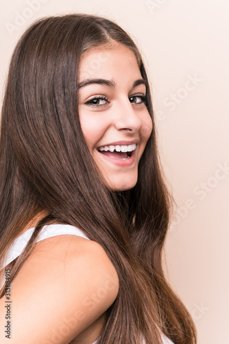 Slika na platnu Young cute caucasian woman against a beige background
