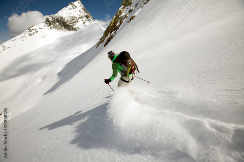 Woman skiing through backcountry powder on a hut trip in British Columbia, Canada. photo