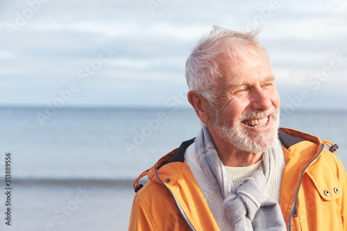 Head And Shoulders Shot Of Active Senior Man Walking Along Winter Beach With Sea Behind © Monkey Business