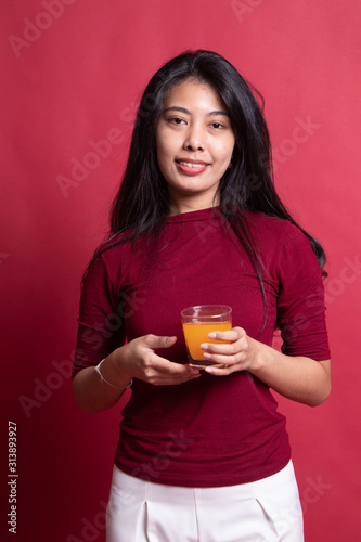 Young Asian woman drink orange juice.