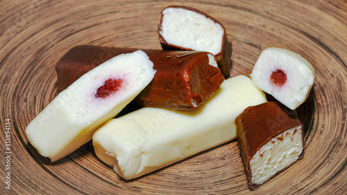 Kohuke chocolate covered cheese curds make sweet Estonian energy bars or cake. Filled with jam and soft sweet whipped curd.