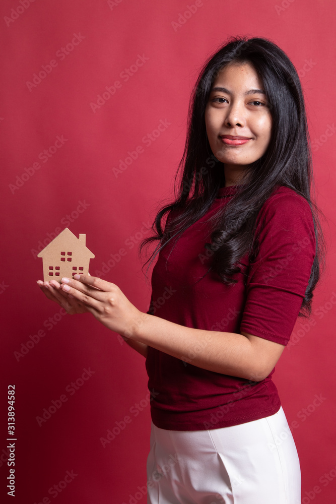 Happy young asian woman with house model. Happy young asian woman with house model.