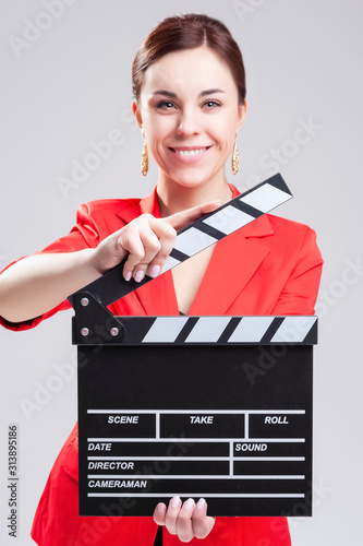 Caucasian Female Posing in Red Blazer with Actioncut Indoors. Focus on Action Cut photo