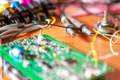 Electronics Ideas. Automotive Printed Circuit Board with Surface Mounted Components and Connected Wire Probes During a Process of Tesing  in Laboratory. photo