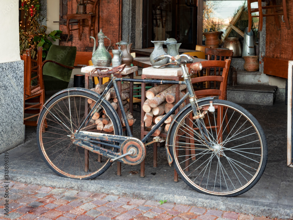 vintage bicycle displayed outside a junk shop