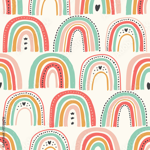 Cute scandinavian childish seamless pattern with trendy hand drawn rainbows