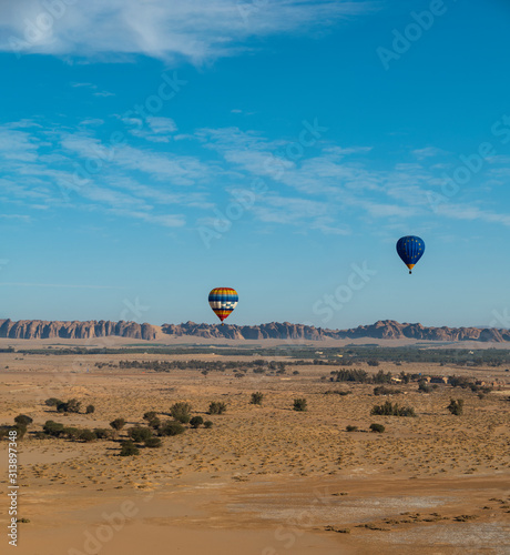 Winter at Tantora Festival hot air balloons fly over Mada'in Saleh (Hegra) ancient archeological site near Al Ula, Saudi Arabia