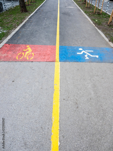 Yellow line divides alley into two lanes for bicycles and pedestrians © tstockphoto