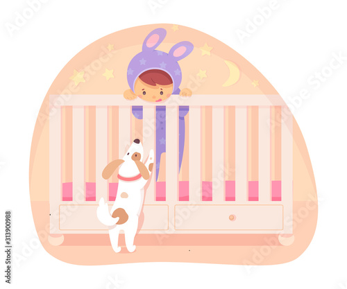 Baby standing in bed and playing with cute puppy