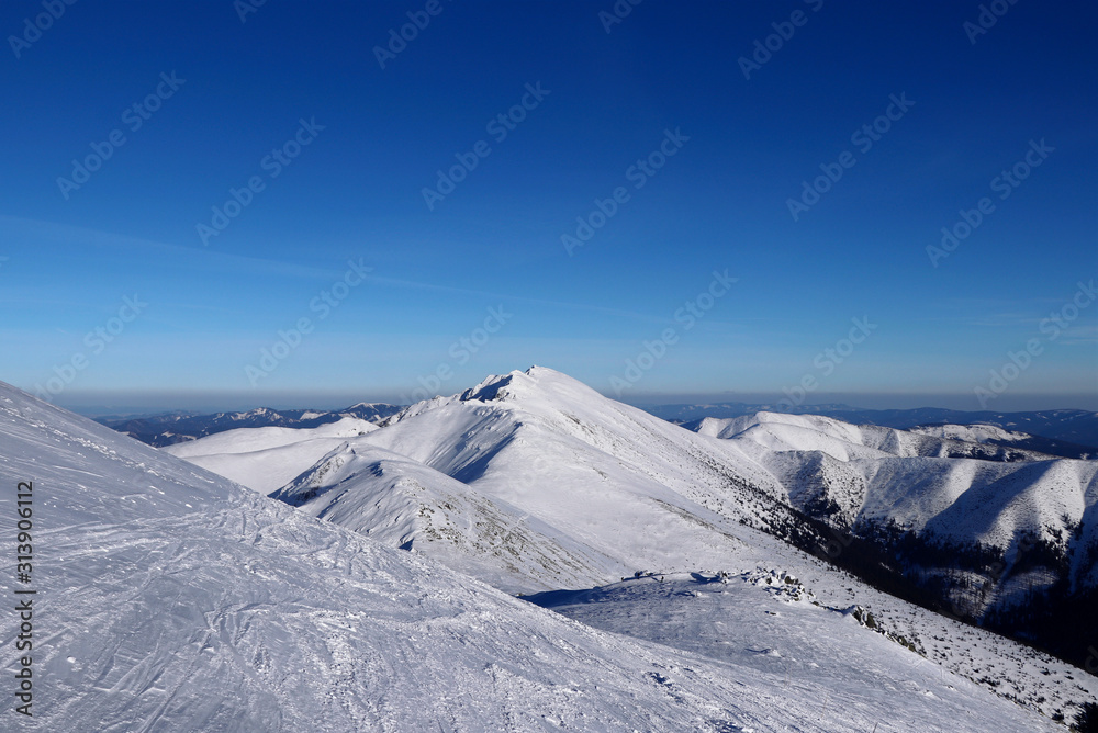 Obraz premium Freeride in Low Tatras with view on Dumbier mountain. Low tatras has beauty same as Alps. The most famous mountain with clean and blue sky. Landscape beauty. Concept of frozen lands
