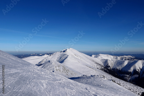 Freeride in Low Tatras with view on Dumbier mountain. Low tatras has beauty same as Alps. The most famous mountain with clean and blue sky. Landscape beauty. Concept of frozen lands © Fauren