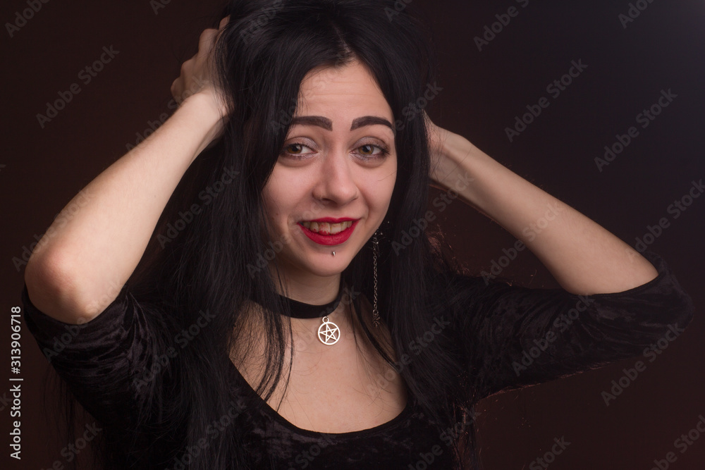 brunette on dark background dressed in goth style brunette on dark background dressed in goth style
