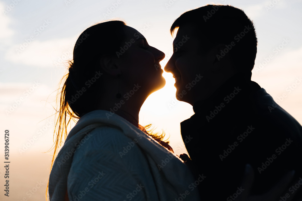 silhouette of romantic couple on sunset