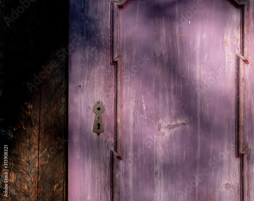Purple door with shadows in old mantion photo