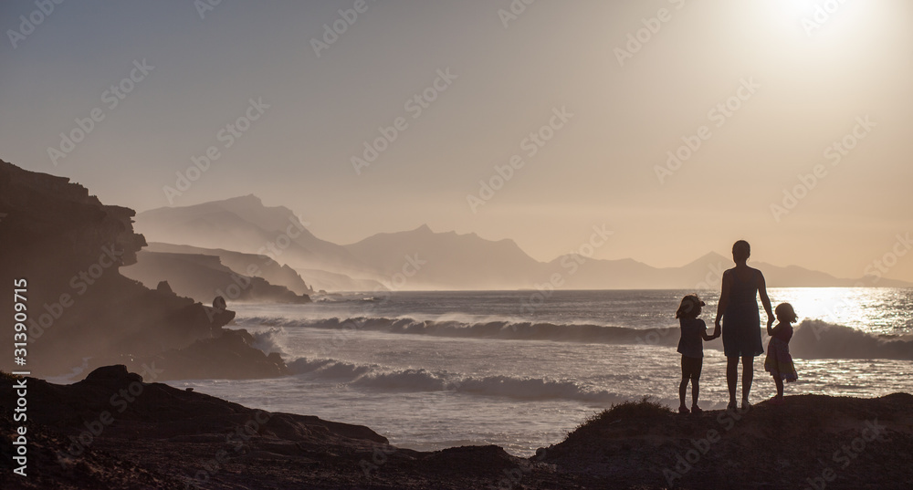 A woman with her children on holiday at Playa De La Pared,  Fuerteventura, Canary Islands, Spain
