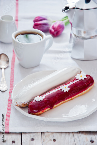 Breakfast with French colorful eclairs with coffee cup