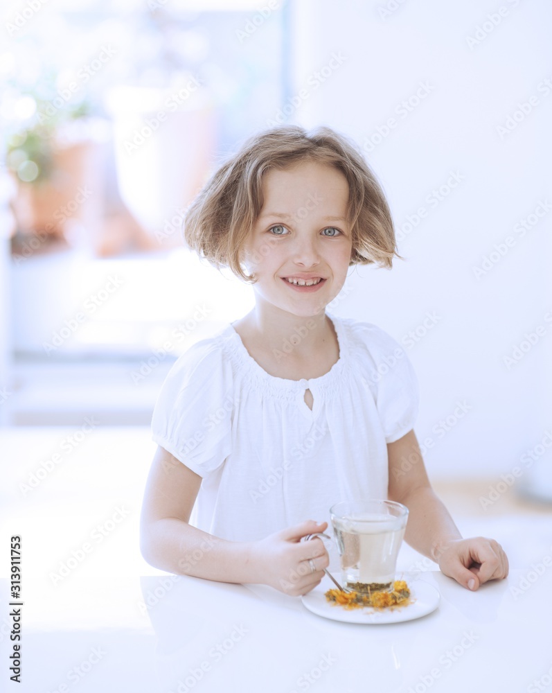 Young girl with cup of tea and flowers Young girl with cup of tea and flowers