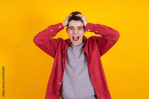 trendy teen boy or student in urban fashion isolated on color background © carballo
