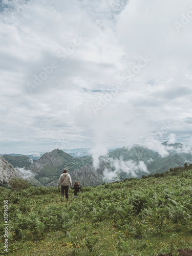 Father and daughter walk through the mountain photo