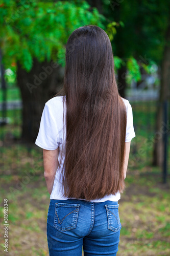 Female brunette hair, rear view, summer park photo