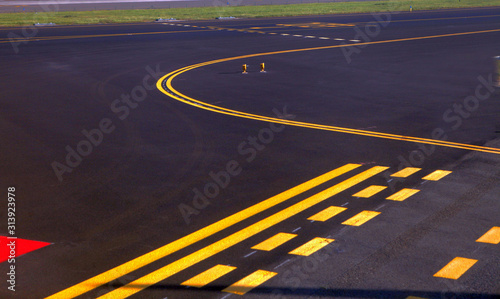 parking lot pavement at the airport with freshly painted yellow lines to mark the stalls.