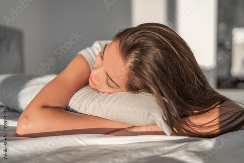 Sleeping on foam pillow bed Asian girl sleeping on stomach sleeper resting head on foam pillow. Hair care silk pillowcase. Good night sleep or midday nap.