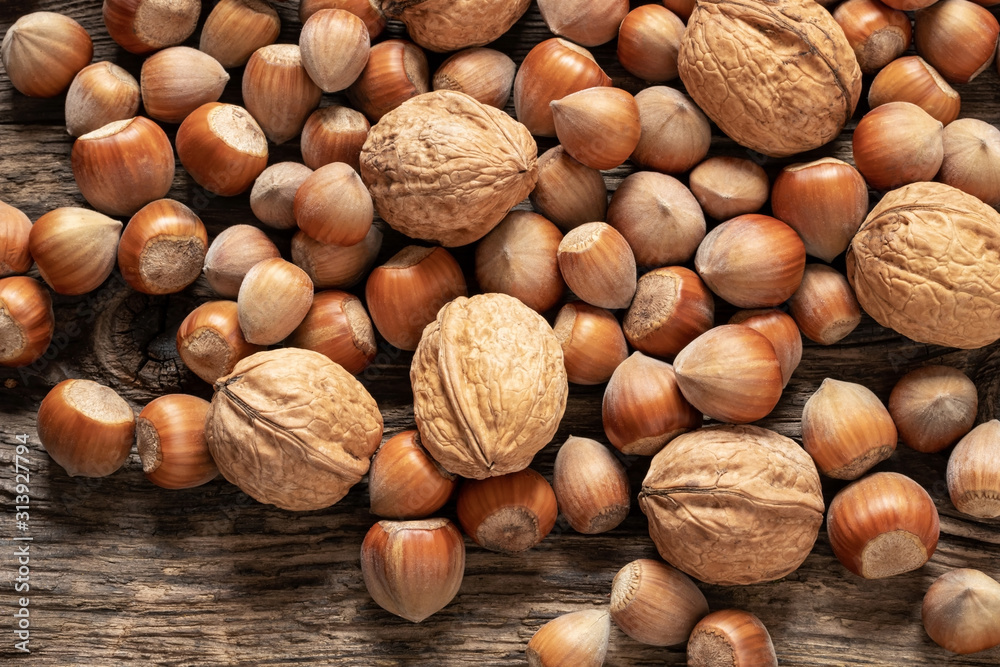 Mix of hazelnuts and walnuts on a wooden table Mix of hazelnuts and walnuts on a wooden table