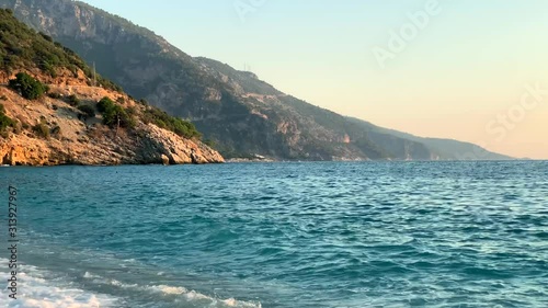 Seaview with beautiful turquoise water and mountains. Summer sea waves. Vacation concept. 4k footage