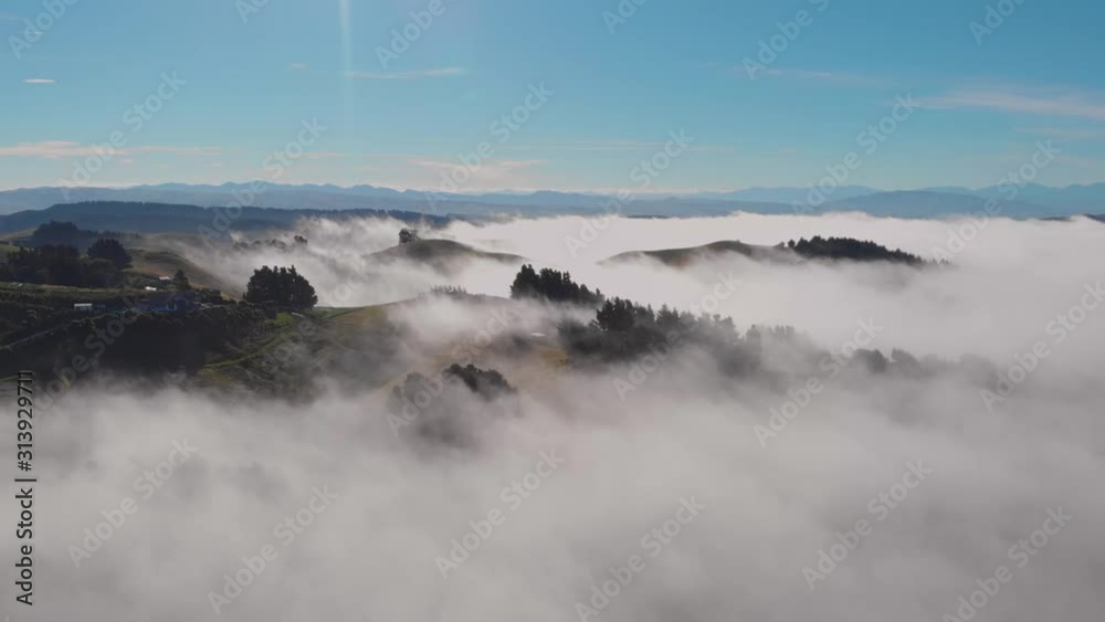 Dreamy view of rolling hills peaking above an ocean of clouds. Canterbury, South Island, New Zealand. Dreamy view of rolling hills peaking above an ocean of clouds. Canterbury, South Island, New Zealand.