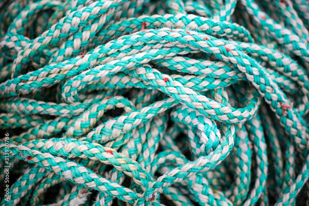 Old light blue and white  frayed fishing boat rope