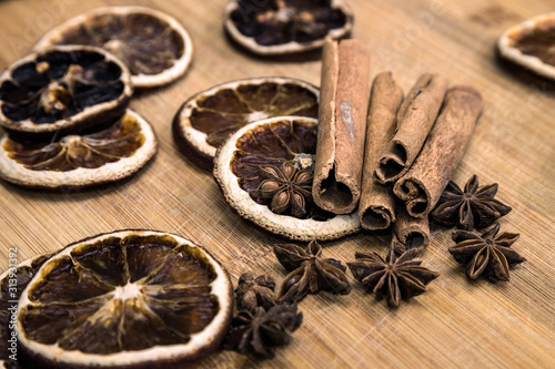 spices on a wooden Board. Anise, star anise, cinnamon and oranges