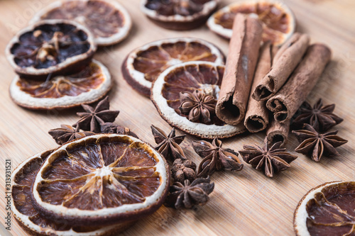 spices on a wooden Board. Anise, star anise, cinnamon and oranges