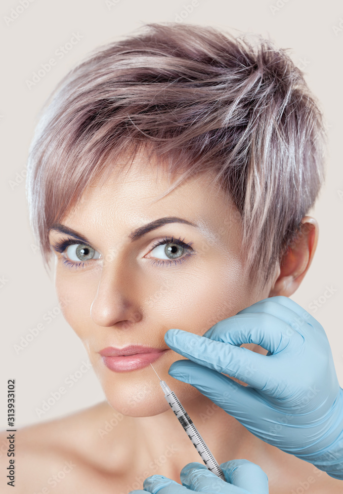 Cosmetologist does prp therapy anti wrinkle and aging skin on the chin and on the face of a beautiful woman in a beauty salon. Cosmetology concept. Cosmetologist does prp therapy anti wrinkle and aging skin on the chin and on the face of a beautiful woman in a beauty salon. Cosmetology concept.