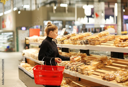 Woman choosing bread  from a supermarket