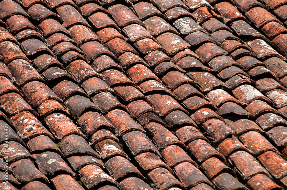 Fototapeta premium Old vintage red ceramic roof tiles closeup as background