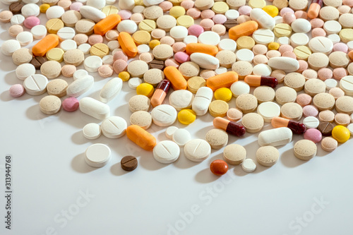 Lots of different multicolored medicinal medicine drugs, pills, tablets, capsules. Pharmacy theme background, closeup, concept