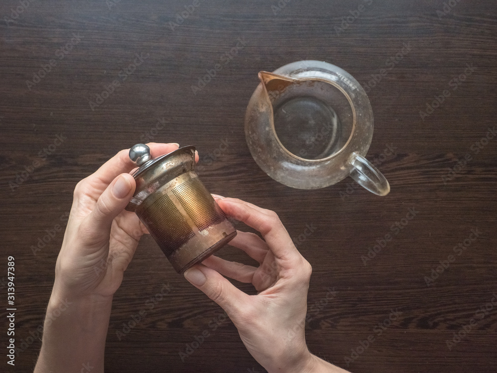 Dirty glass teapot. Tea scale on the teapot. Cleaning the teapot at