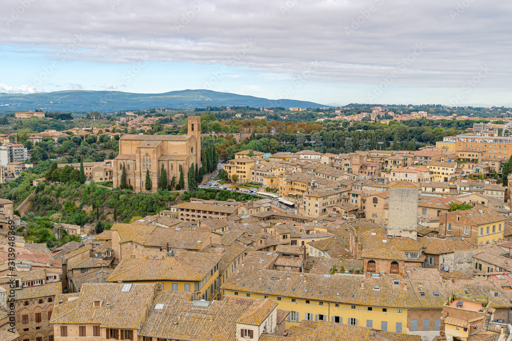 Panoramic view of Siena city with roofs, Piazza del Campo and the Torre del Mangia is a tower in city from Siena