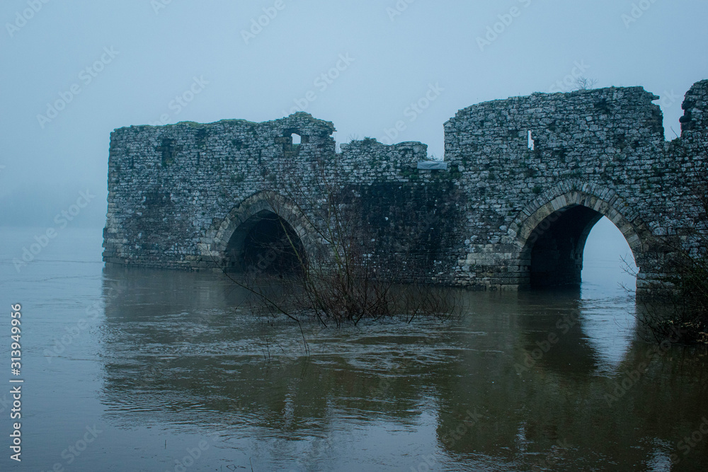 Submerged castle in ruin with fog